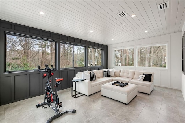 sunroom / solarium featuring a healthy amount of sunlight and wooden ceiling