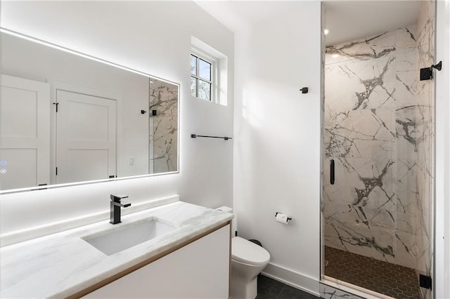 bathroom featuring a shower with door, vanity, and toilet