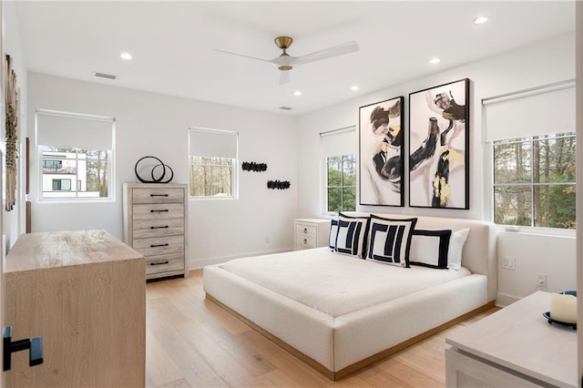 bedroom with ceiling fan and light wood-type flooring