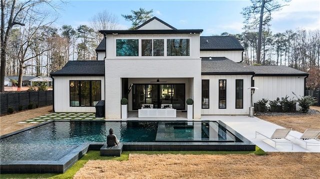 back of property featuring a fenced in pool, a yard, a patio, and ceiling fan