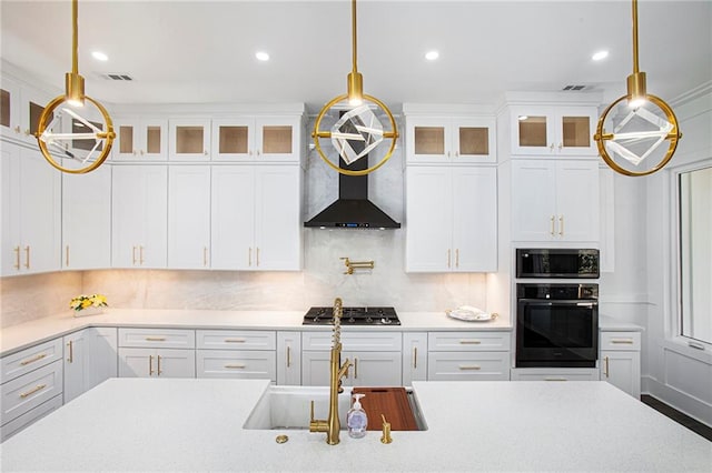 kitchen featuring white cabinets, pendant lighting, and appliances with stainless steel finishes