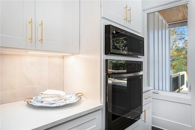 kitchen with white cabinets and appliances with stainless steel finishes