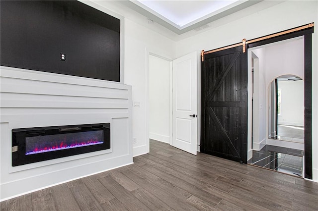 entrance foyer featuring a barn door and dark hardwood / wood-style floors