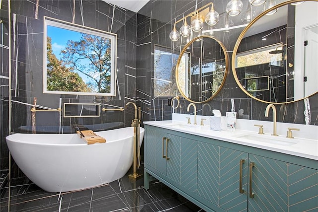 bathroom with tile walls, a washtub, and vanity