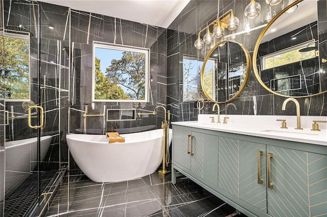 bathroom with tile walls, vanity, tile patterned floors, and separate shower and tub