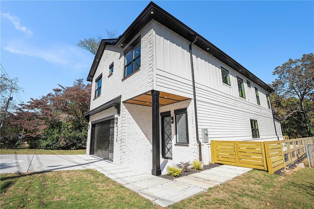 view of property exterior with a garage and a lawn