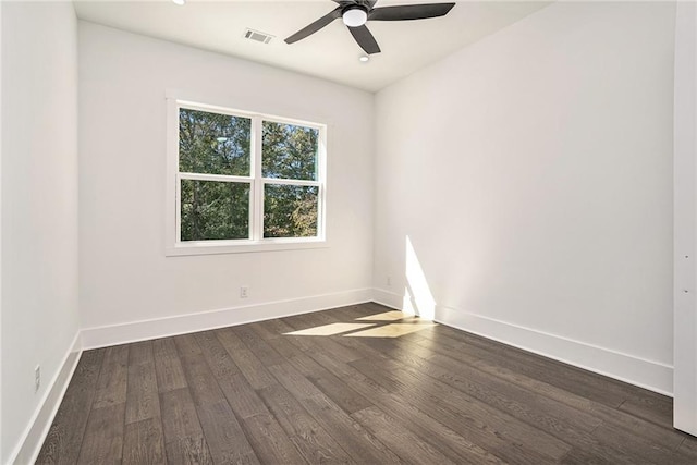 spare room featuring dark wood-type flooring and ceiling fan