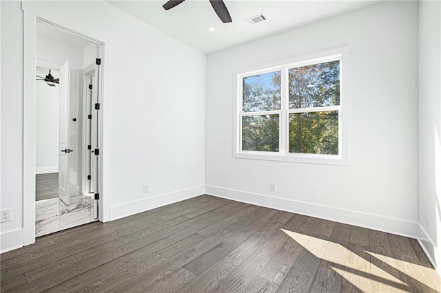 unfurnished room featuring dark wood-type flooring and ceiling fan