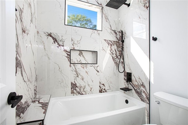 bathroom with tiled shower / bath combo and toilet