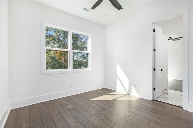 unfurnished room featuring dark wood-type flooring and ceiling fan