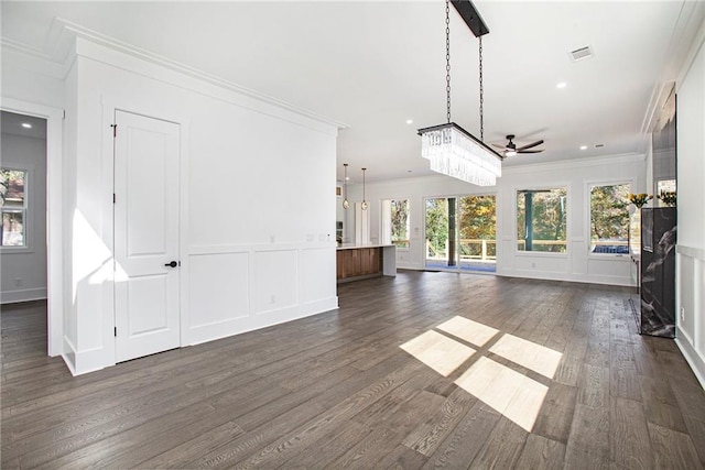 unfurnished living room with dark wood-type flooring, ceiling fan, and ornamental molding