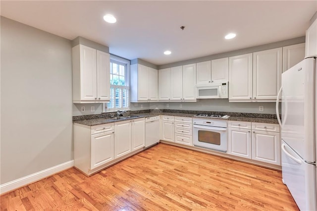 kitchen with white cabinets and white appliances