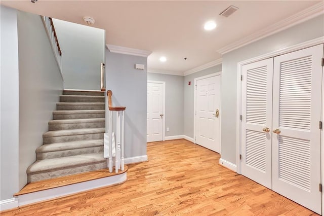 interior space featuring crown molding and hardwood / wood-style floors