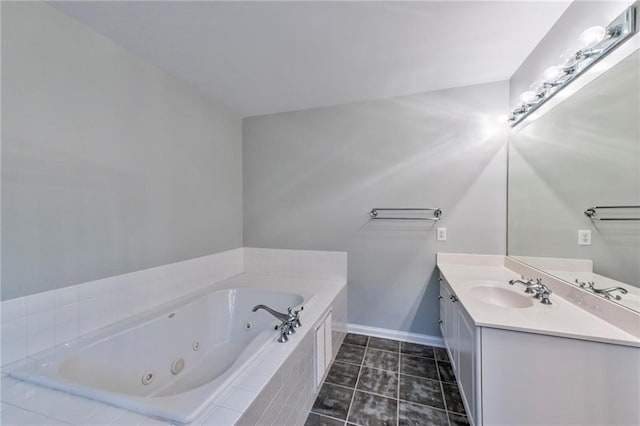 bathroom featuring tile patterned floors, vanity, and tiled tub