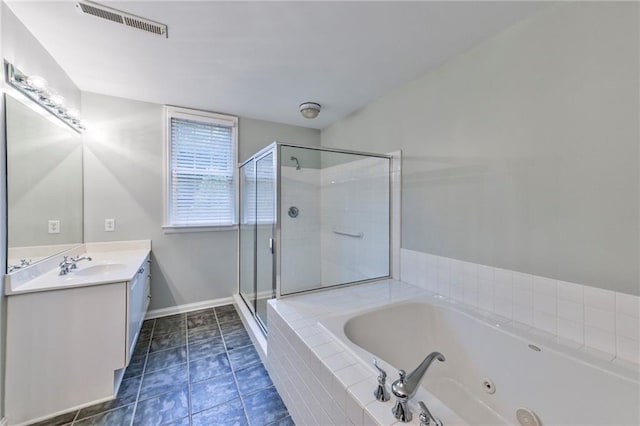 bathroom with vanity and shower with separate bathtub