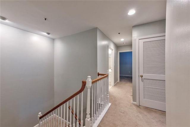 hallway with light colored carpet