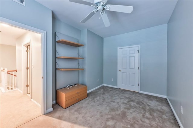 unfurnished bedroom with ceiling fan and carpet