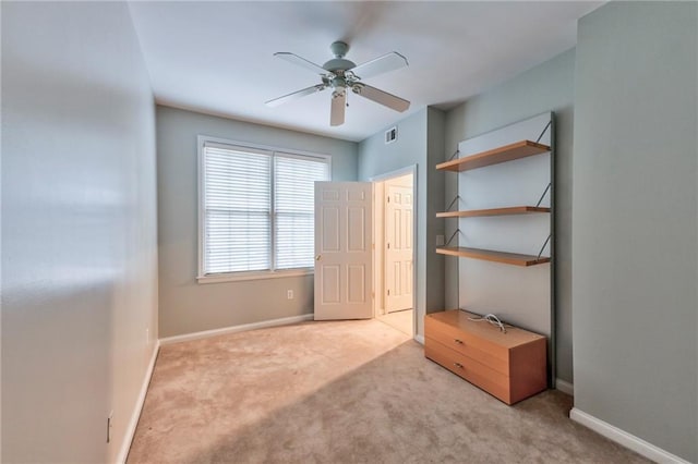 unfurnished bedroom with ceiling fan and light colored carpet