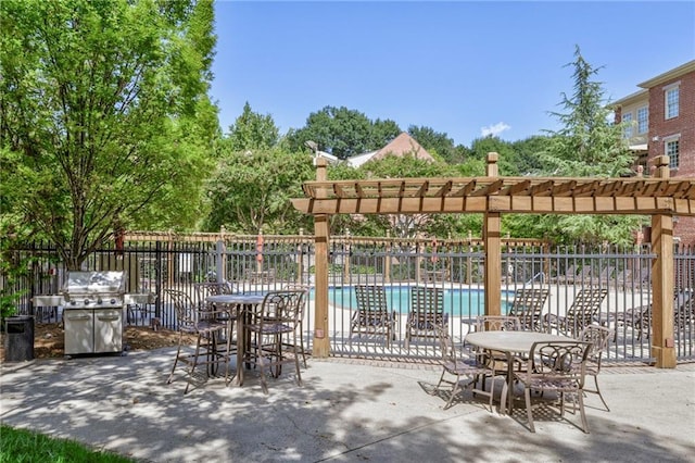 view of patio featuring area for grilling, a community pool, and a pergola