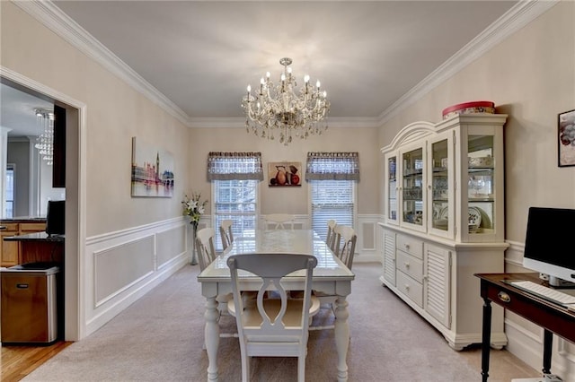 carpeted dining space with ornamental molding and a notable chandelier