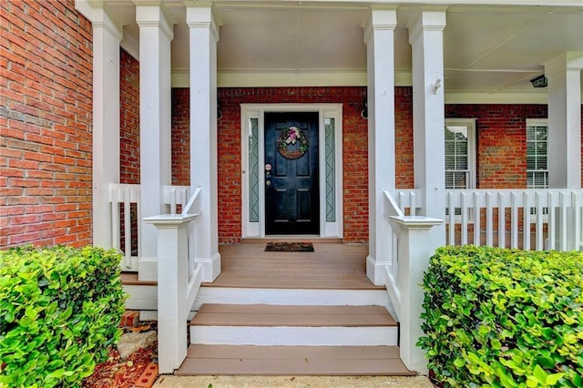 view of exterior entry featuring a porch