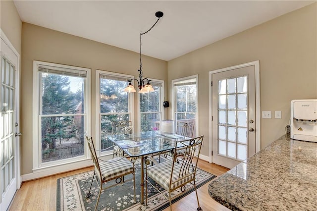 dining room with a chandelier and light hardwood / wood-style flooring