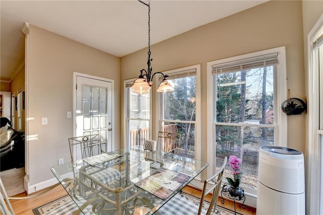 dining area featuring hardwood / wood-style flooring and a chandelier