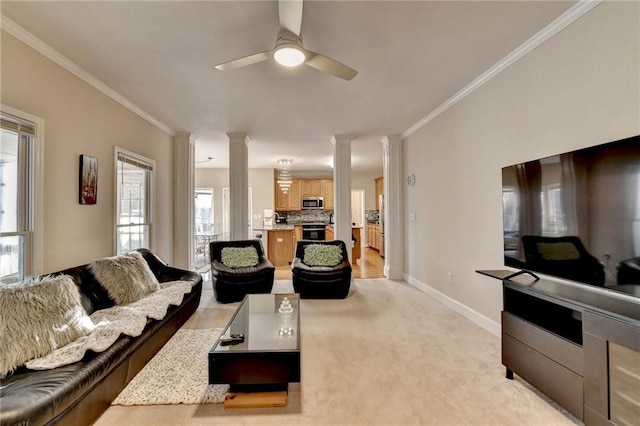 living room featuring decorative columns, crown molding, light carpet, and ceiling fan