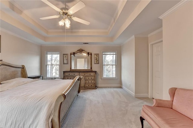 bedroom featuring multiple windows, a tray ceiling, light colored carpet, and crown molding