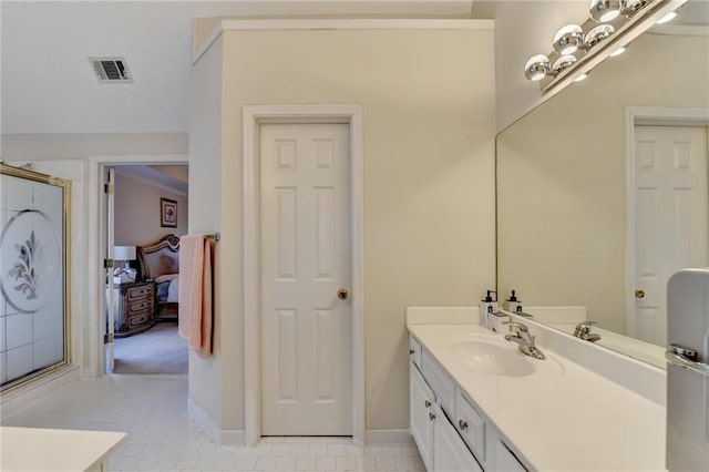 bathroom with vanity, tile patterned floors, and walk in shower