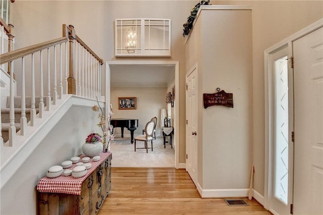 foyer with a notable chandelier and light wood-type flooring