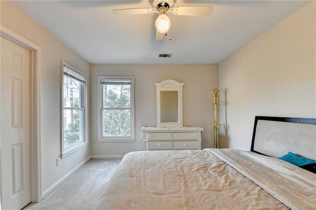 unfurnished bedroom featuring light carpet and ceiling fan