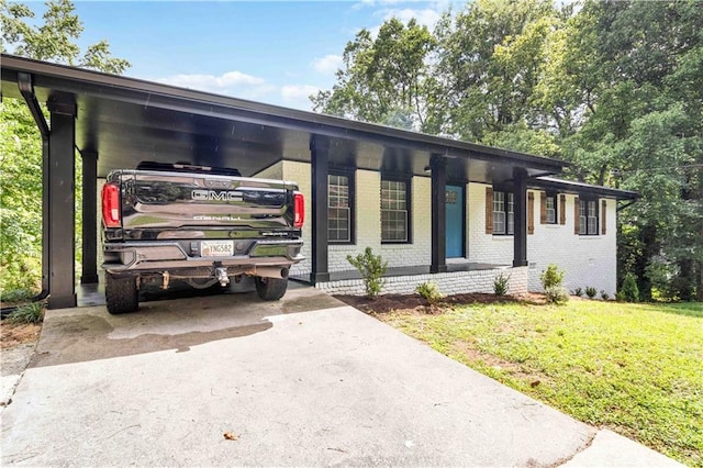 view of front of house with a carport and a front lawn