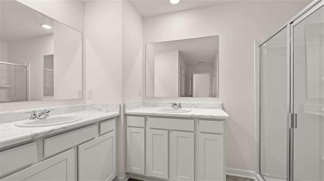 364 Sound Cir, Stockbridge, GA 30281 - bathroom featuring a shower stall, two vanities, and recessed lighting