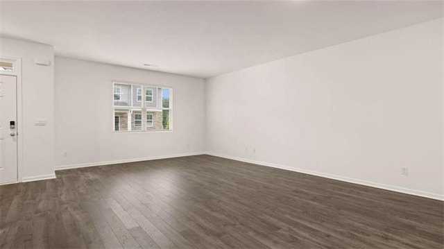 364 Sound Cir, Stockbridge, GA 30281 - spare room with dark wood-style floors and baseboards