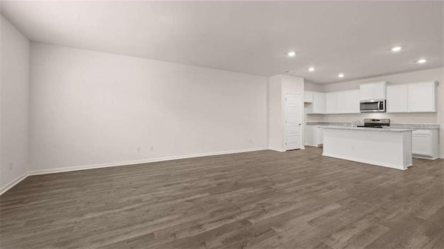 364 Sound Cir, Stockbridge, GA 30281 - unfurnished living room featuring dark wood-style flooring and recessed lighting