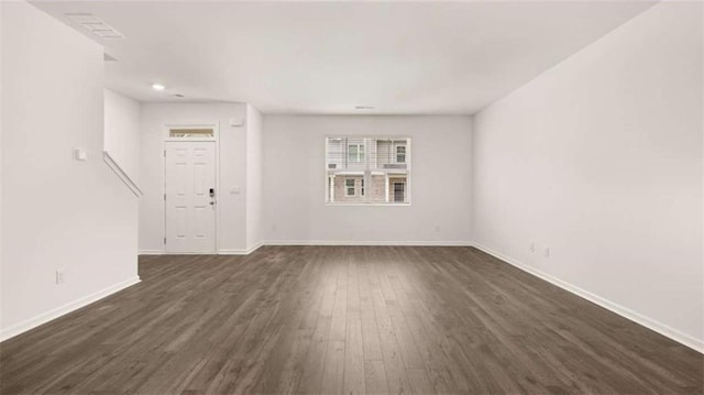 364 Sound Cir, Stockbridge, GA 30281 - unfurnished living room with dark wood-type flooring and baseboards