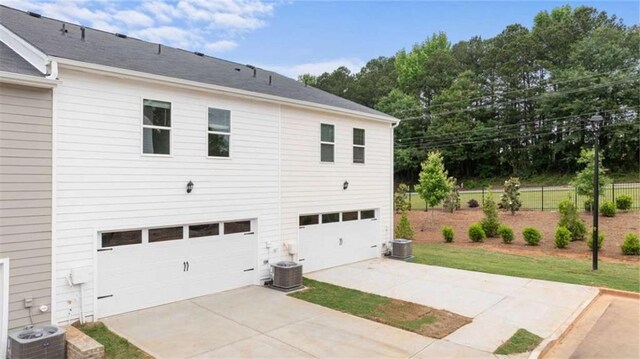 364 Sound Cir, Stockbridge, GA 30281 - rear view of house with a garage and concrete driveway