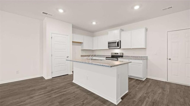 364 Sound Cir, Stockbridge, GA 30281 - kitchen featuring appliances with stainless steel finishes, white cabinetry, dark wood finished floors, and recessed lighting