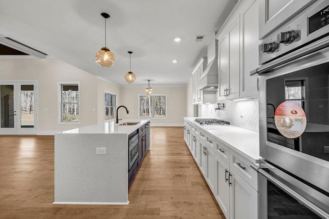 125 Drummond Pl, Covington, GA 30014 - kitchen with a sink, light countertops, hanging light fixtures, backsplash, and recessed lighting