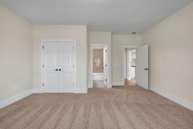 125 Drummond Pl, Covington, GA 30014 - unfurnished bedroom featuring carpet, baseboards, a closet, and ensuite bath