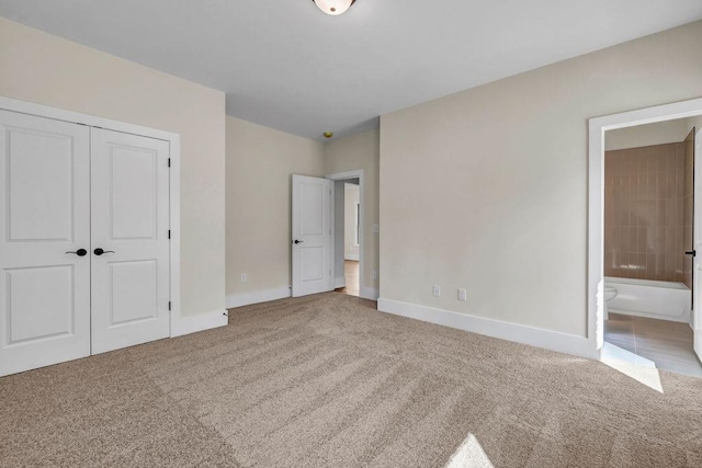 125 Drummond Pl, Covington, GA 30014 - unfurnished bedroom with carpet flooring, baseboards, ensuite bathroom, and a closet