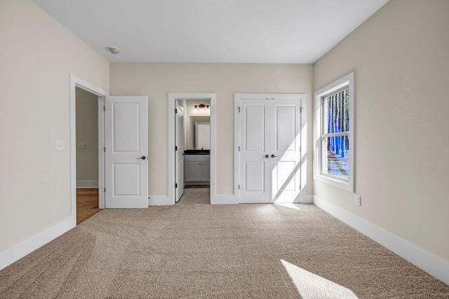 125 Drummond Pl, Covington, GA 30014 - unfurnished bedroom with carpet flooring, connected bathroom, and baseboards