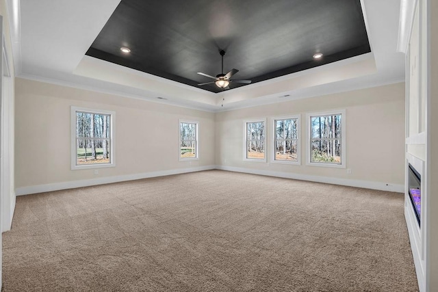 125 Drummond Pl, Covington, GA 30014 - carpeted empty room with a tray ceiling, a ceiling fan, baseboards, a fireplace, and recessed lighting