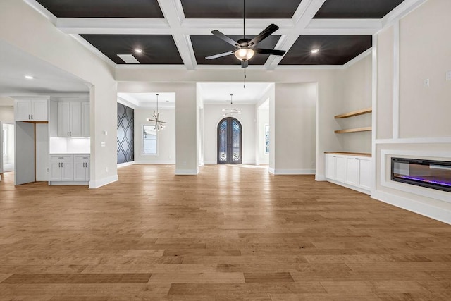 125 Drummond Pl, Covington, GA 30014 - unfurnished living room with light wood-style floors, baseboards, ornamental molding, coffered ceiling, and ceiling fan