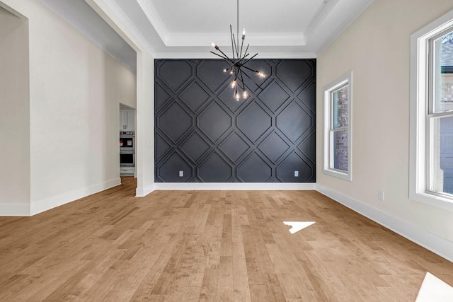 125 Drummond Pl, Covington, GA 30014 - unfurnished dining area featuring a chandelier, light wood-style floors, baseboards, and crown molding