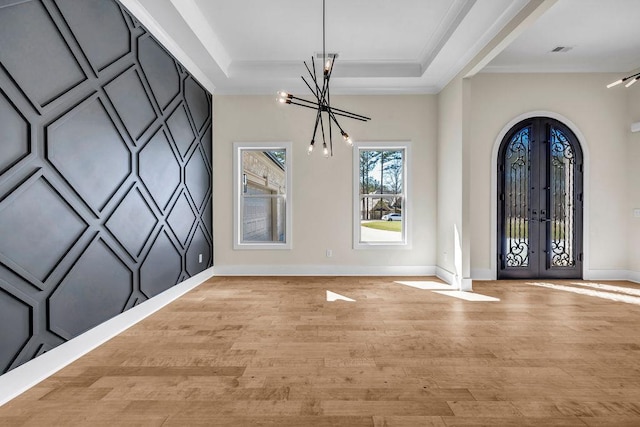 125 Drummond Pl, Covington, GA 30014 - foyer entrance with french doors, a chandelier, light wood finished floors, baseboards, and ornamental molding