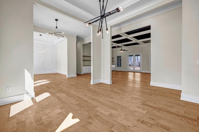 125 Drummond Pl, Covington, GA 30014 - unfurnished dining area featuring a chandelier, coffered ceiling, beamed ceiling, light wood-style flooring, and baseboards