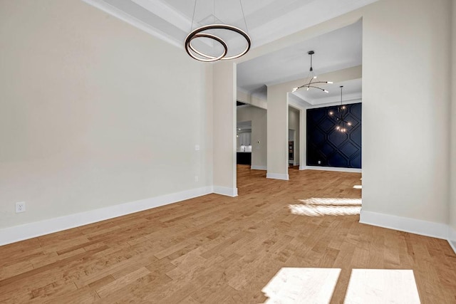 125 Drummond Pl, Covington, GA 30014 - unfurnished dining area featuring a chandelier, a raised ceiling, baseboards, light wood-style flooring, and ornamental molding
