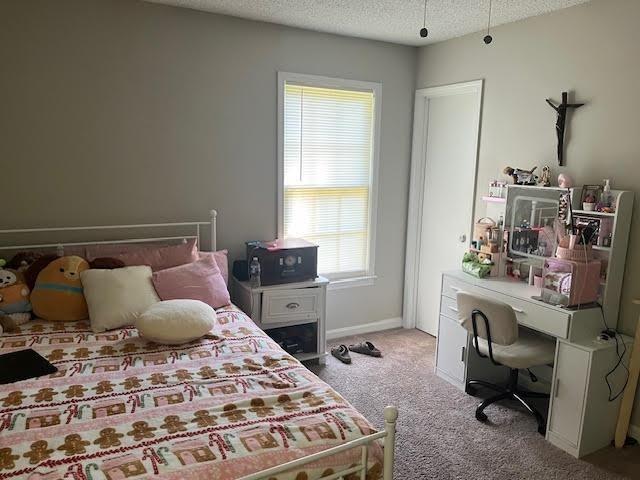 231 Forest Pl, Lawrenceville, GA 30046 - carpeted bedroom featuring a textured ceiling and a desk
